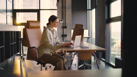 A skilled professional excels in a modern office, using advanced technology and  Stock Footage 282178626