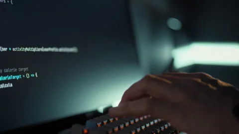 Skilled professional rapidly inputs complex code on computer swiftly updatin Stock Footage 331865771
