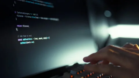 A skilled programmer rapidly types intricate website code on a computer keyb Stock Footage 331456122