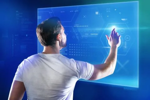 Skilled programmer working with a new device and touching a transparent screen Stock-Fotos