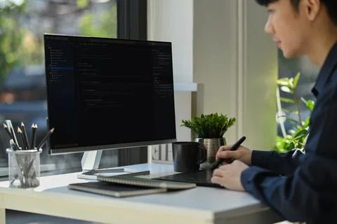 Skilled programmer working on web site project in a software developing on Stock Photos