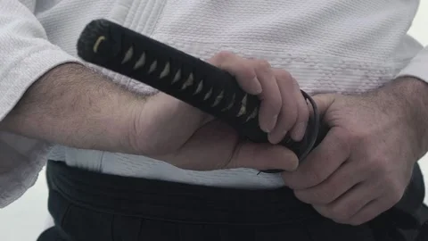 Skilled samurai holds katana case and takes Japanese saber Stock Footage 131940363