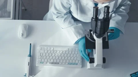 A skilled scientist is diligently analyzing biological samples in a wellequipped Stock Footage 317026916