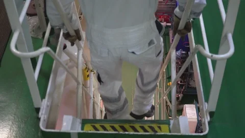 Skilled ship engineer wearing headphones walks downstairs Stock Footage 117587928