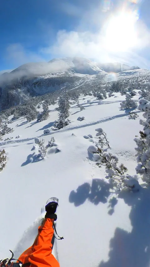 Skilled snowboarder carving through pristine powder Stock Footage 262553004