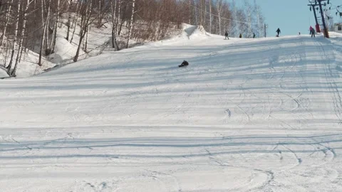 Skilled snowboarder extremely carves down the hill at high speed at a ski resort Stock Footage 221745678
