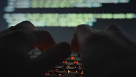 A skilled software engineer rapidly enters intricate code into a computer ut Stock Footage 331865742