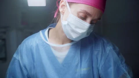 Skilled surgeon performing intricate procedure in a modern operating room during Stock Footage 295864027
