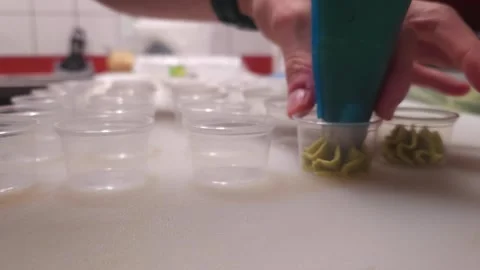The skilled sushi master deftly squeezes fresh wasabi from confectionery bag Stock Footage 268741580