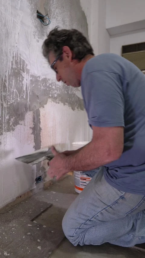 Skilled Taping Job: Applying White Mud to Drywall Seam Stock Footage 323987531