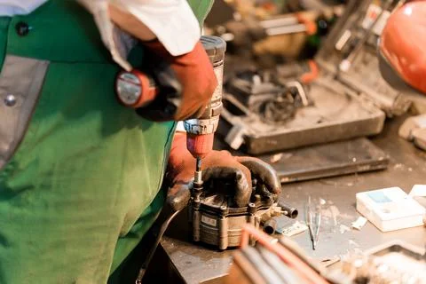 Skilled Technician Assembling Mechanical Components with Power Tools in a Wor Stock Photos