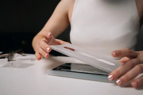 Skilled technician female using specialized machine to precisely apply Stock Photos