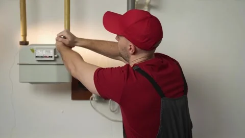 Skilled Technician Performs Gas Meter Maintenance in a Residential Building Stock Footage 270045694