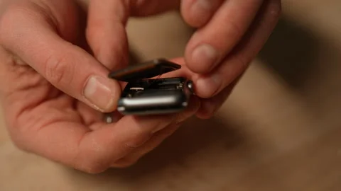 Skilled technician preparation to replacement smartwatch battery, showing Stock Footage 301401065