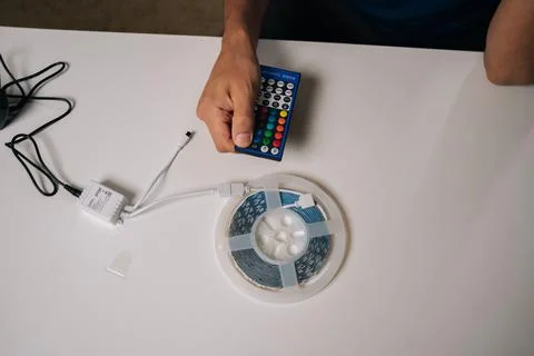 Skilled technician preparing RGB controller with led strip, configuring lighting Stock Photos