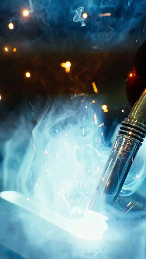 Skilled welder working on metal project in industrial workshop Stock Footage 300347580