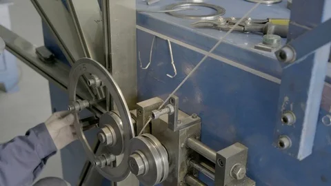 A skilled worker in blue measures the dimensions of a part using a vernier Stock Footage 127038309