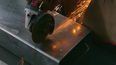 Skilled worker cutting an iron pipe with a grinder video with sound Stock Footage 312335040