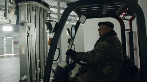 Skilled worker driving a warehouse loader before the dispatch Stock Footage 227049000