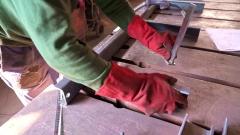 Skilled worker fabricates metal components in workshop during daytime hours 動画素材 310953677