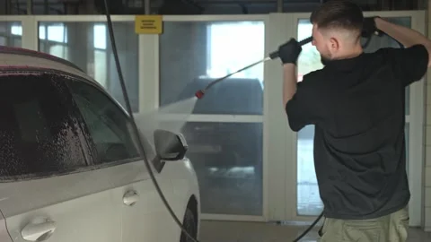 Skilled Worker Meticulously Cleans Car Exterior Stock Footage 335214197