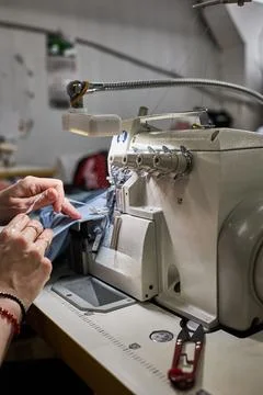 Skilled Worker Operating an Overlock Sewing Machine Stock Photos