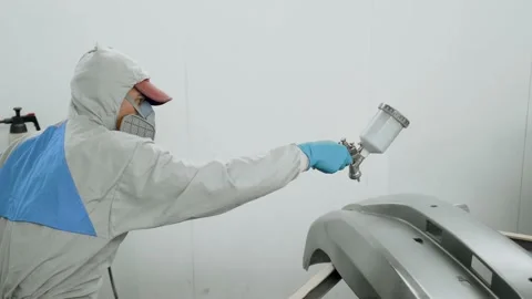 Skilled worker in protective suit painted auto body detail with holding air Stock-Footage 150918115