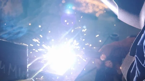 Skilled worker in special helmet welds metal rebar elements Stock Footage 124892923