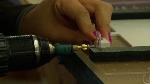 A skilled worker uses a power drill and screws to attach plastic parts in a fact Stock Footage 71041676