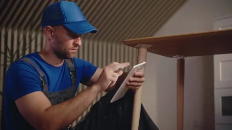 Skilled worker using a tablet to plan woodworking project for furniture creation Vídeo Stock 294914328