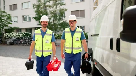Skilled Workers On Duty: HVAC Electrician And Plumber Near Van Stock Footage 313364034