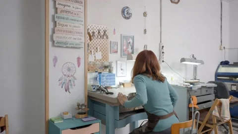 Skilled Young Artisan Making Pet Accessory Looks At Her Small Notepad. Stock Footage 193988259