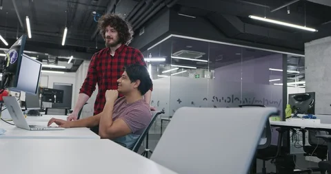 Skilled young it professionals cooperating on common software project using l Video stock 113933464