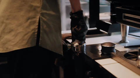 Skillful Barista Preparing Coffee with Filter Basket – Close-Up Shot Stockbeeldmateriaal 307593920