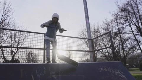 Skillful boy riding up and down in skateboarders park practicing risky sports Stock Footage 239868647