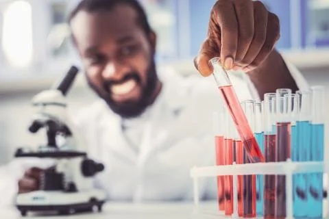 Skillful chemist placing test tubes in order Stock Photos