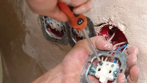 Skillful Electrician Installing Wall Electrical Outlet With Care And Precision Stock Footage 328521168
