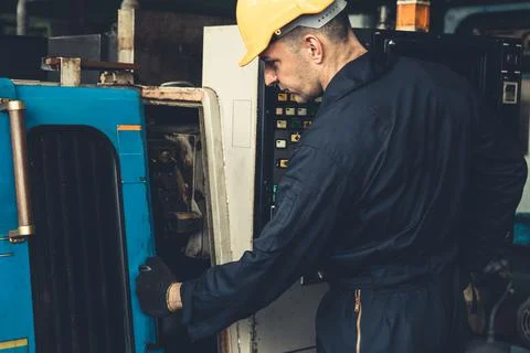 Skillful factory engineer or worker do machine job in manufacturing workshop Stock Photos