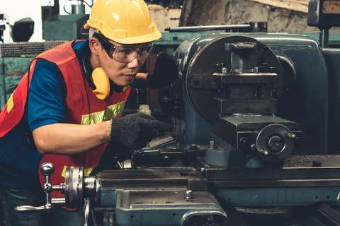 Skillful factory worker or engineer do machine job in manufacturing workshop Stock Photos