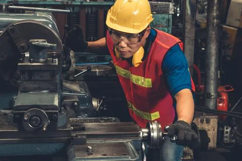 Skillful factory worker or engineer do machine job in manufacturing workshop Stock Photos