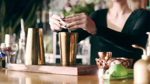 Skillful female bartender cracking egg and separating yolk from whites over a co Stock Footage 199463003