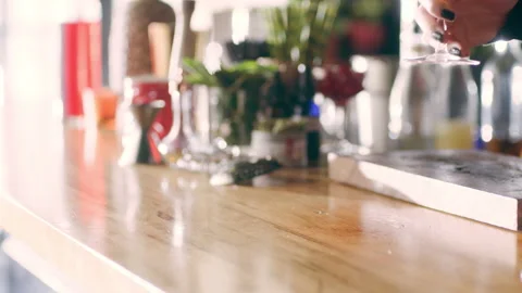 Skillful female bartender serving a bourbon sour in a fancy bar with soft interi Stock Footage 199461844