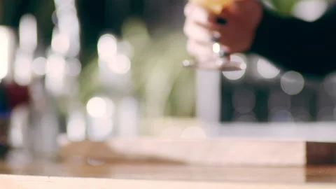 Skillful female bartender serving a bourbon sour in a fancy bar with soft interi Stock Footage 199463637