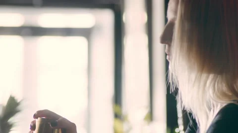 Skillful female bartender shaking a cocktail shaker in the air in a fancy bar wi Stock Footage 199458341