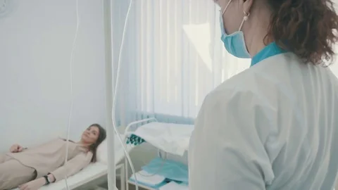 Skillful general practitioner is putting dropper in hospital Stock Footage 74575293