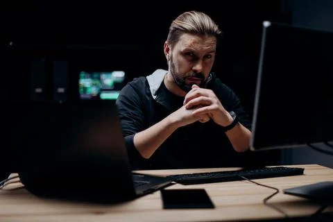 Skillful hacker working on computers Stock Photos