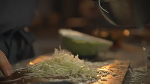 The skillful hands of a chef create a blend of fresh sustainably grown cabba Stock Footage 333502040