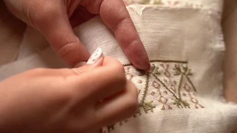 Skillful hands create beautiful embroidery in a bright workshop Stock Footage 317999219