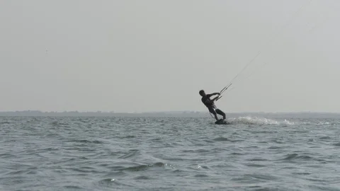 Skillful kiteboarder does Front Roll trick slow motion Stock Footage 118991974