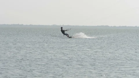 Skillful kiteboarder rides fast forward beach slow motion Stock Footage 118993391